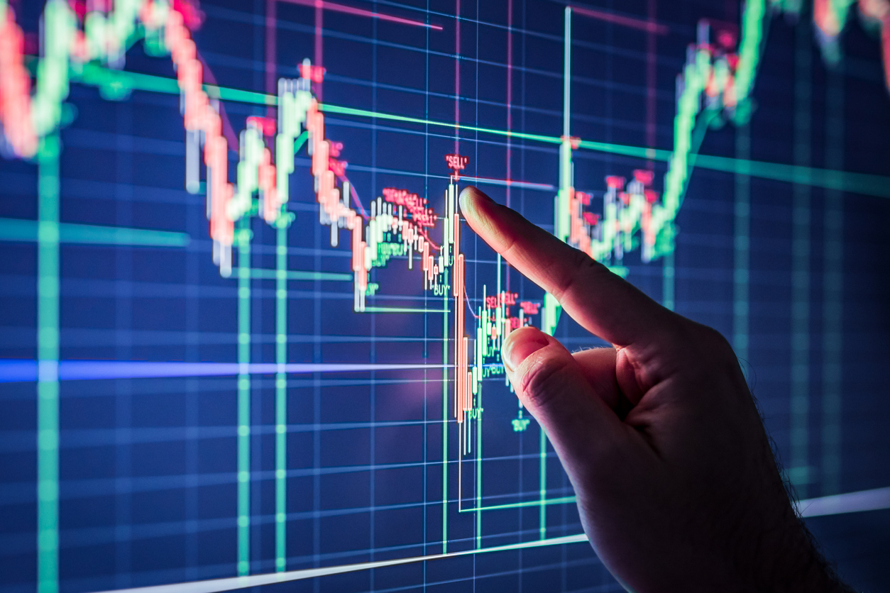 Hand going over chart to backtest trading strategy | AfterPullback